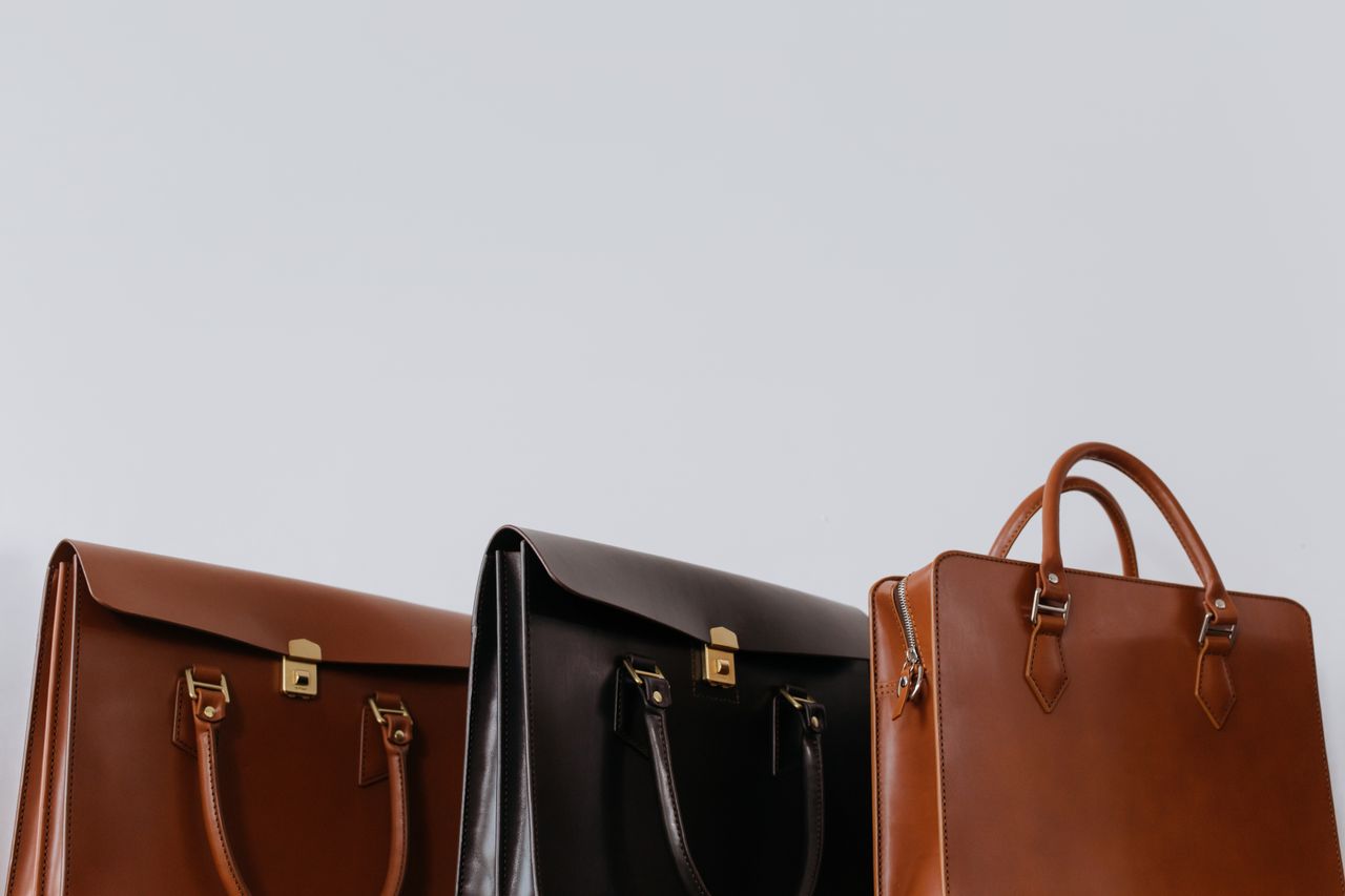 why-choose-us A close-up view of three elegant leather briefcases emphasizing luxury and fashion.